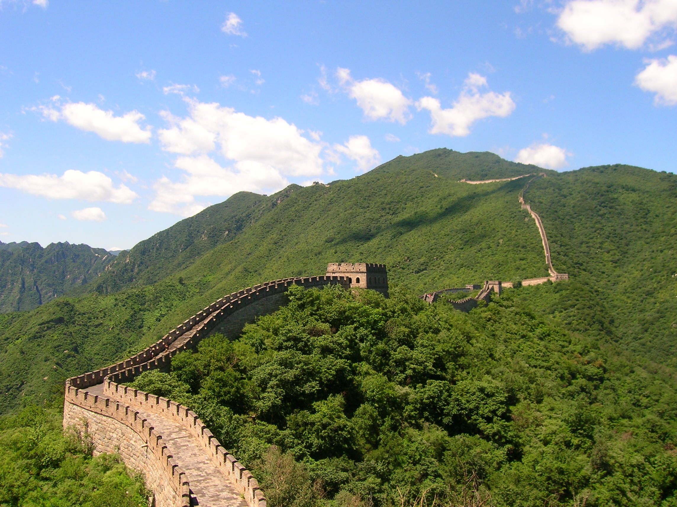 The Great Wall following a green mountain ridge at Mutianyu near Beijing